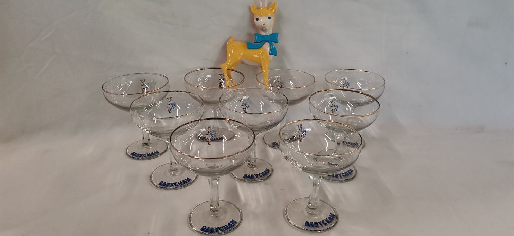 Lot 202: A Set of Ten Vintage Babycham Champagne Coupe Glasses and a Promotional Mascot Figure