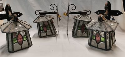 A Set of Four Arts and Crafts Style Leaded Glass and Wrought Iron Wall Lanterns. A set of four 