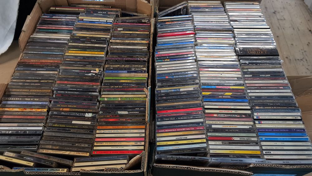 Lot 390: A Collection of Assorted Compact Discs including Rock, Pop, and Heavy Metal