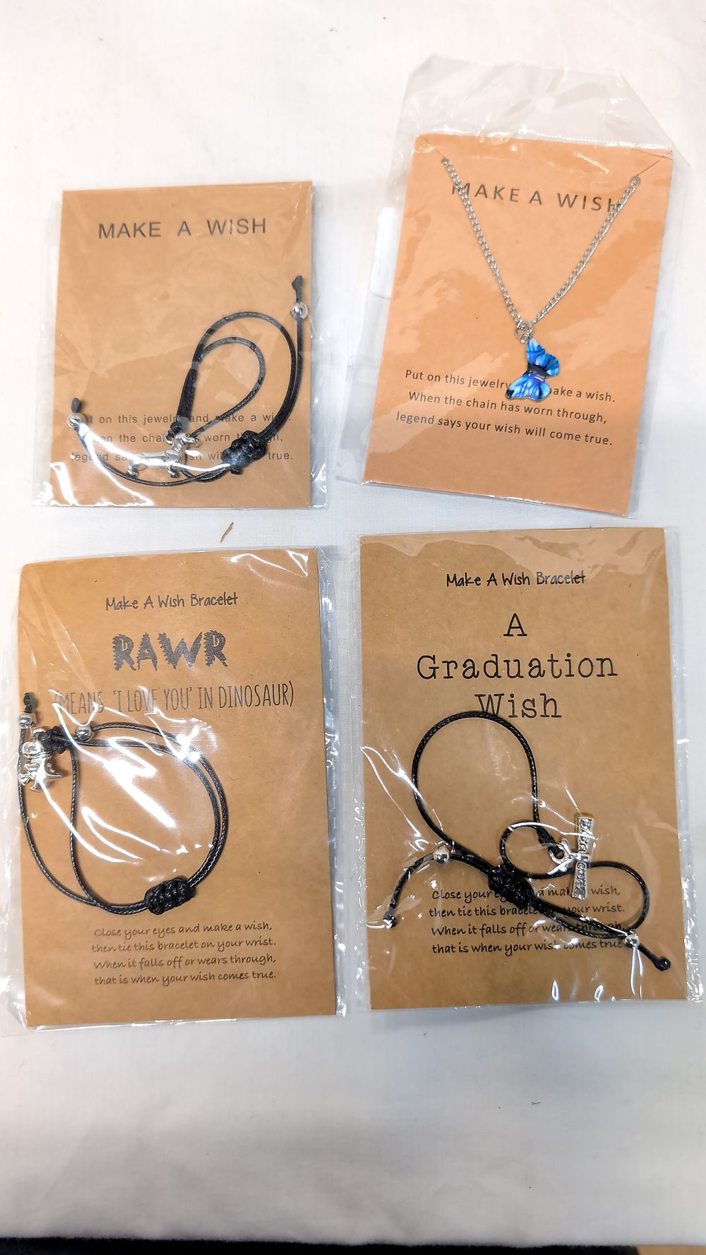Lot 538: A Collection of Novelty Wish Bracelets and a Butterfly Necklace