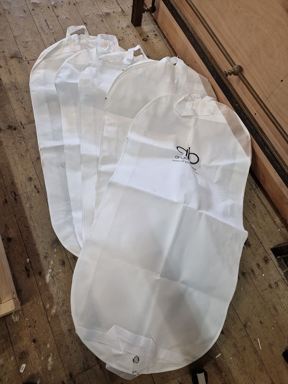 Lot 546: A Collection of Five Angela Beer Branded Garment Covers