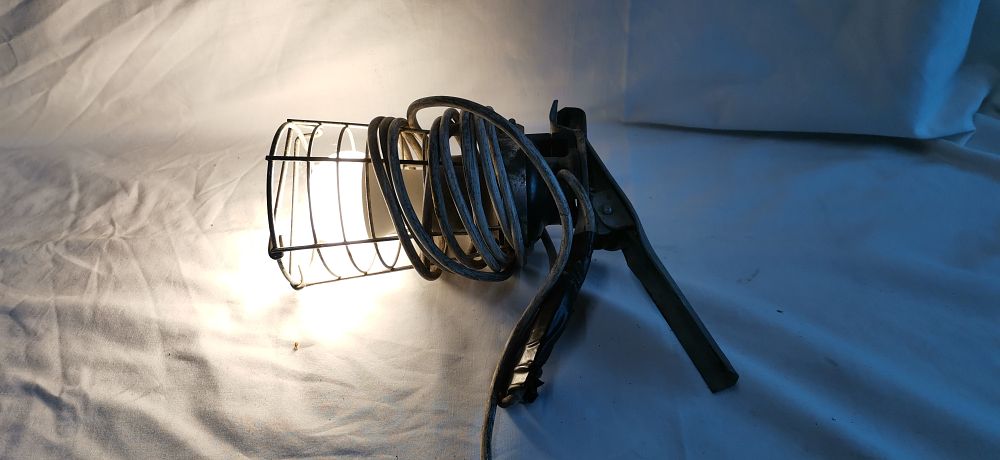 Lot 584: An industrial portable metal cage clamp-on inspection lamp. Tested for Power