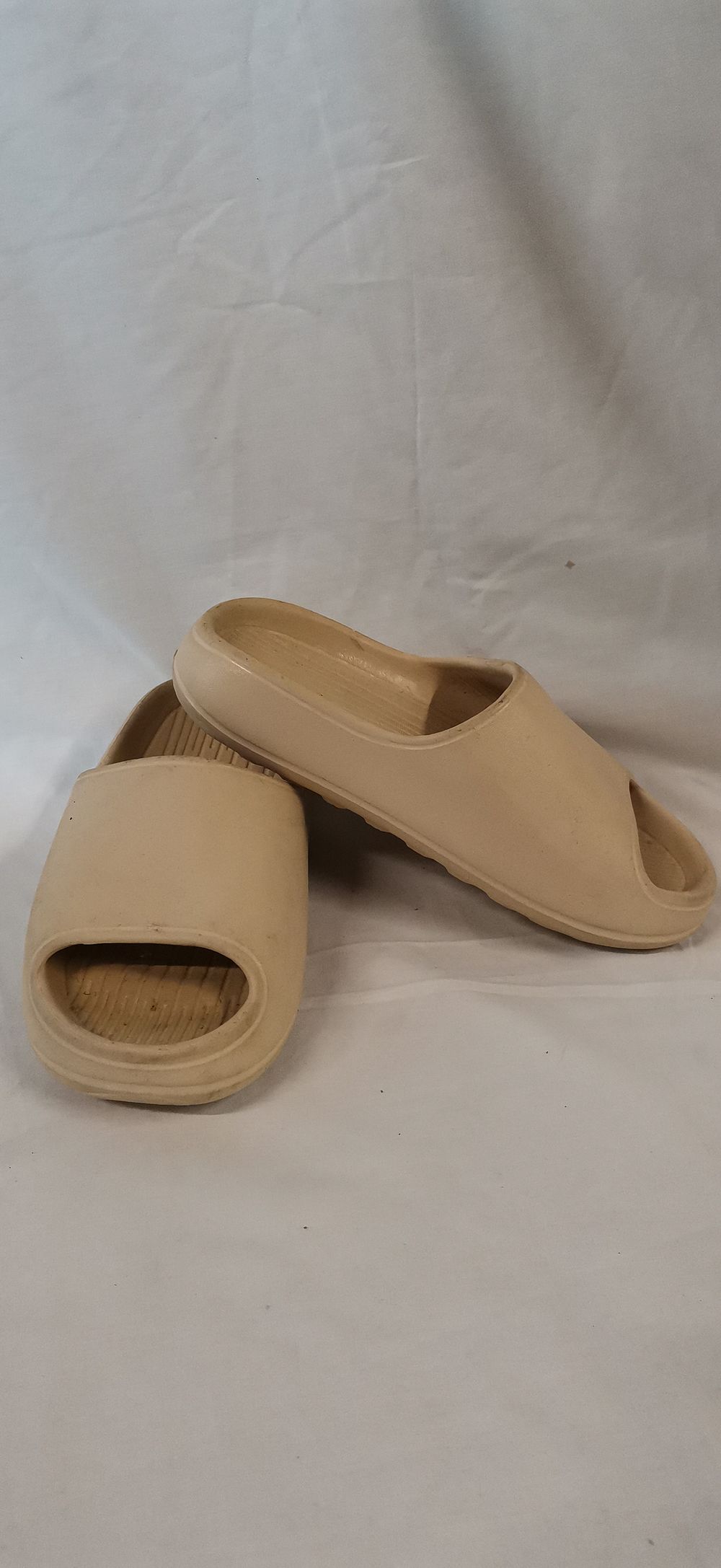 Lot 659: A Pair of Beige Moulded EVA Foam Slide Sandals