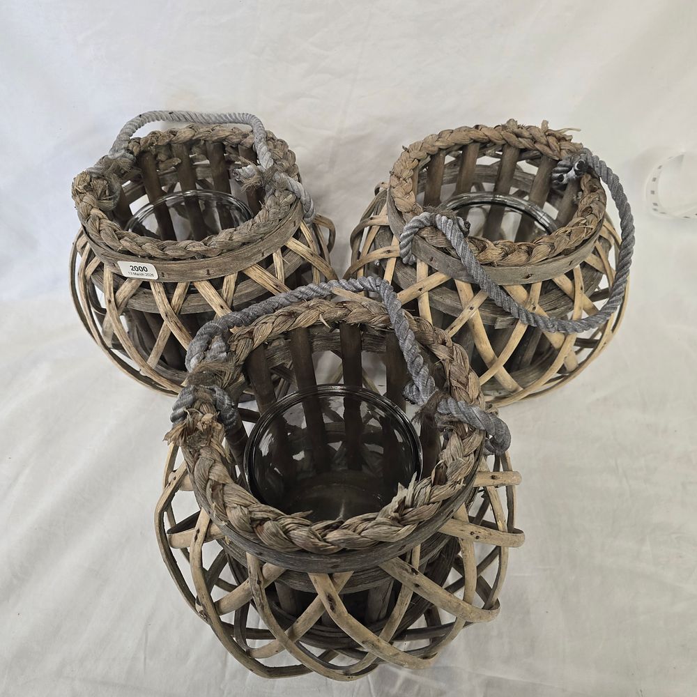 Lot 713: A Trio of Contemporary Woven Willow and Rattan Lanterns with glass inserts