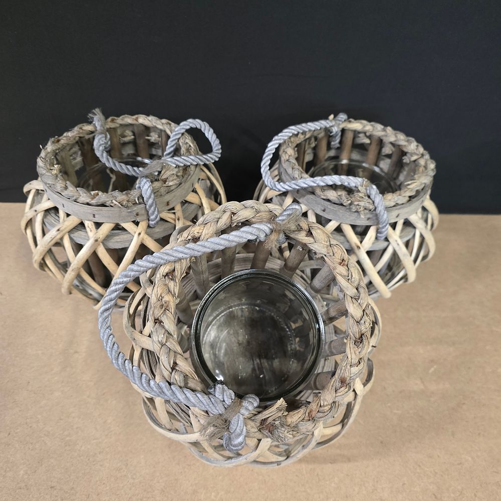 Lot 720: A Trio of Contemporary Rustic Woven Willow and Rattan Lanterns with glass inserts