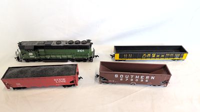 An Assortment of HO Scale American Outline Model Railway Locomotives and Freight Wagons. This 