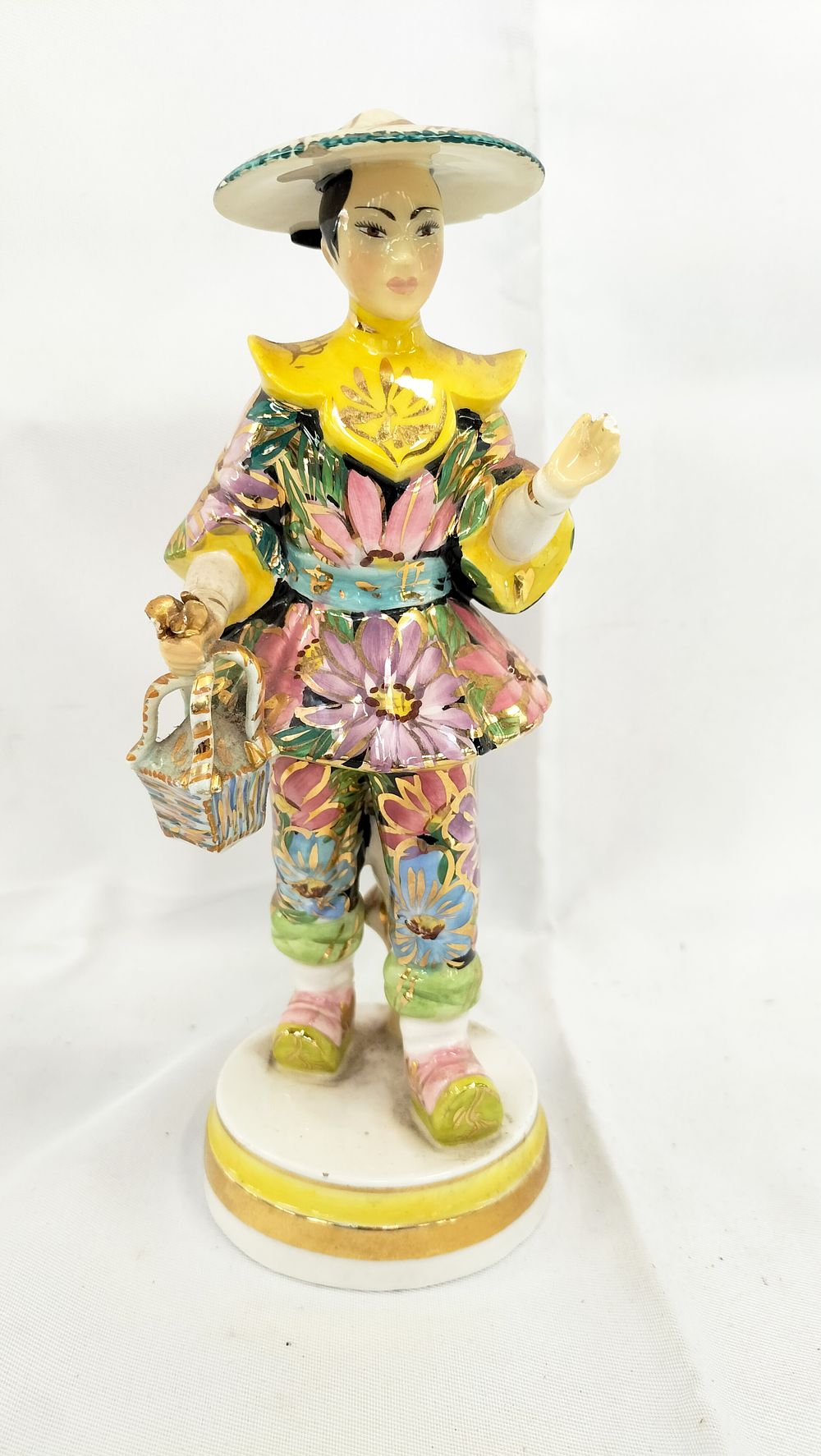 Lot 451: Italian Chinoiserie Polychrome Porcelain Figurine of a Figure with Basket