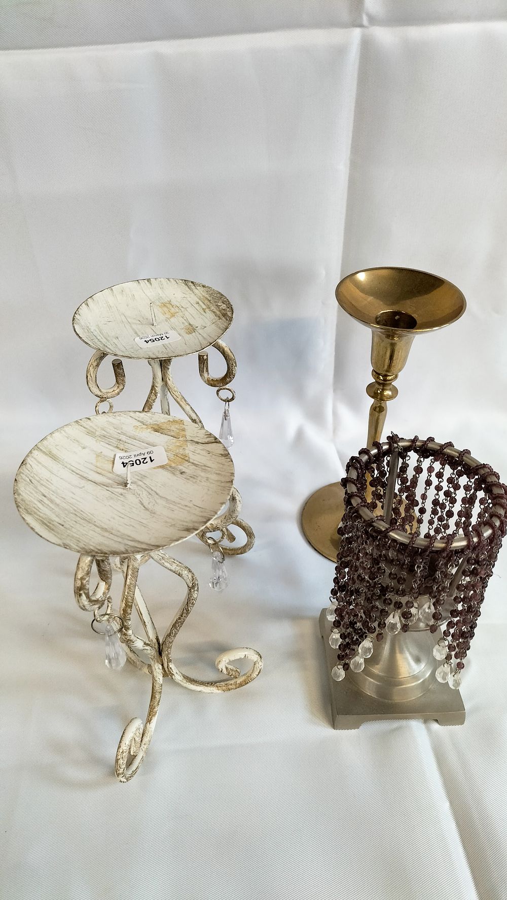 Lot 479: A collection of assorted decorative metal candle holders including a pair of pricket stands