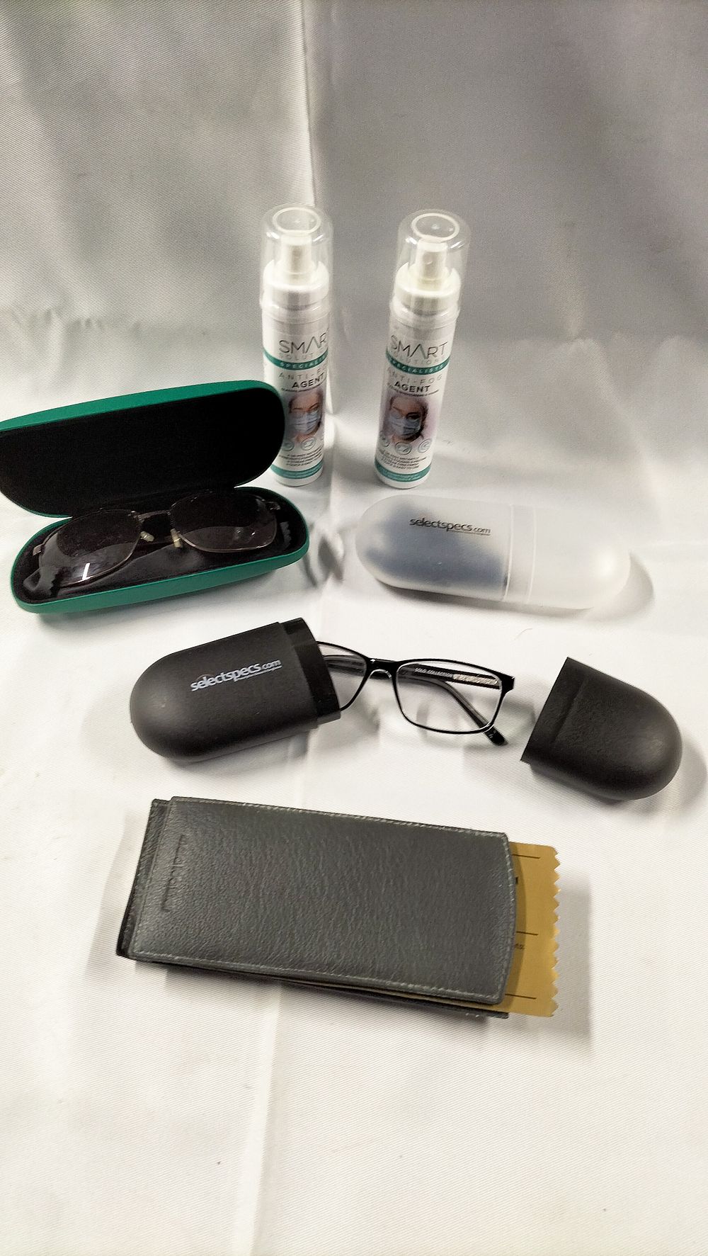 Lot 594: A Collection of Eyewear, Protective Cases, and Anti-Fog Cleaning Solutions