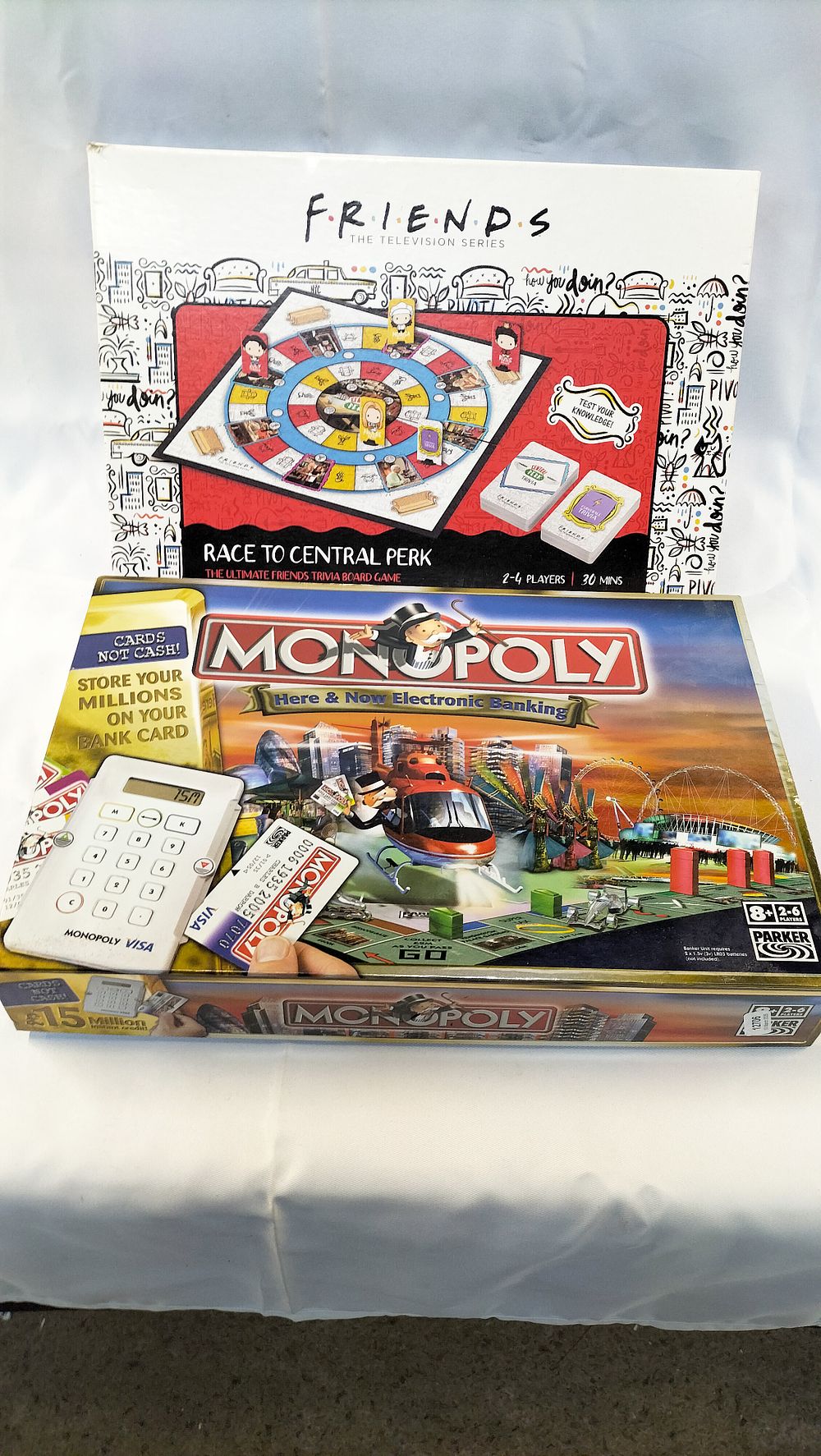 Lot 596: Two Board Games comprising Monopoly Here & Now Electronic Banking Edition and Friends Race to Central Perk Trivia