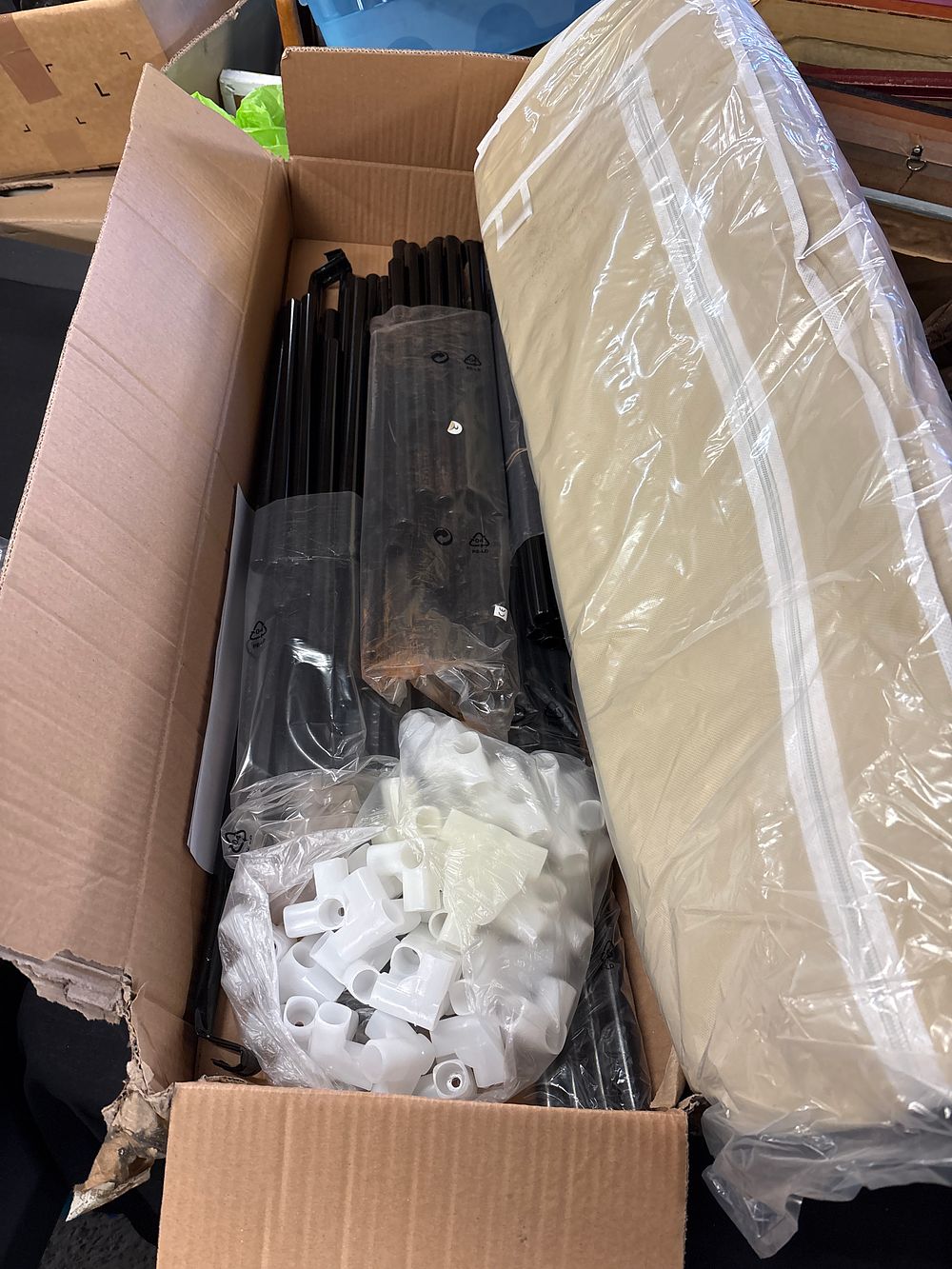Lot 761: A Collection of Portable Garment Rack Components with Garment Cover