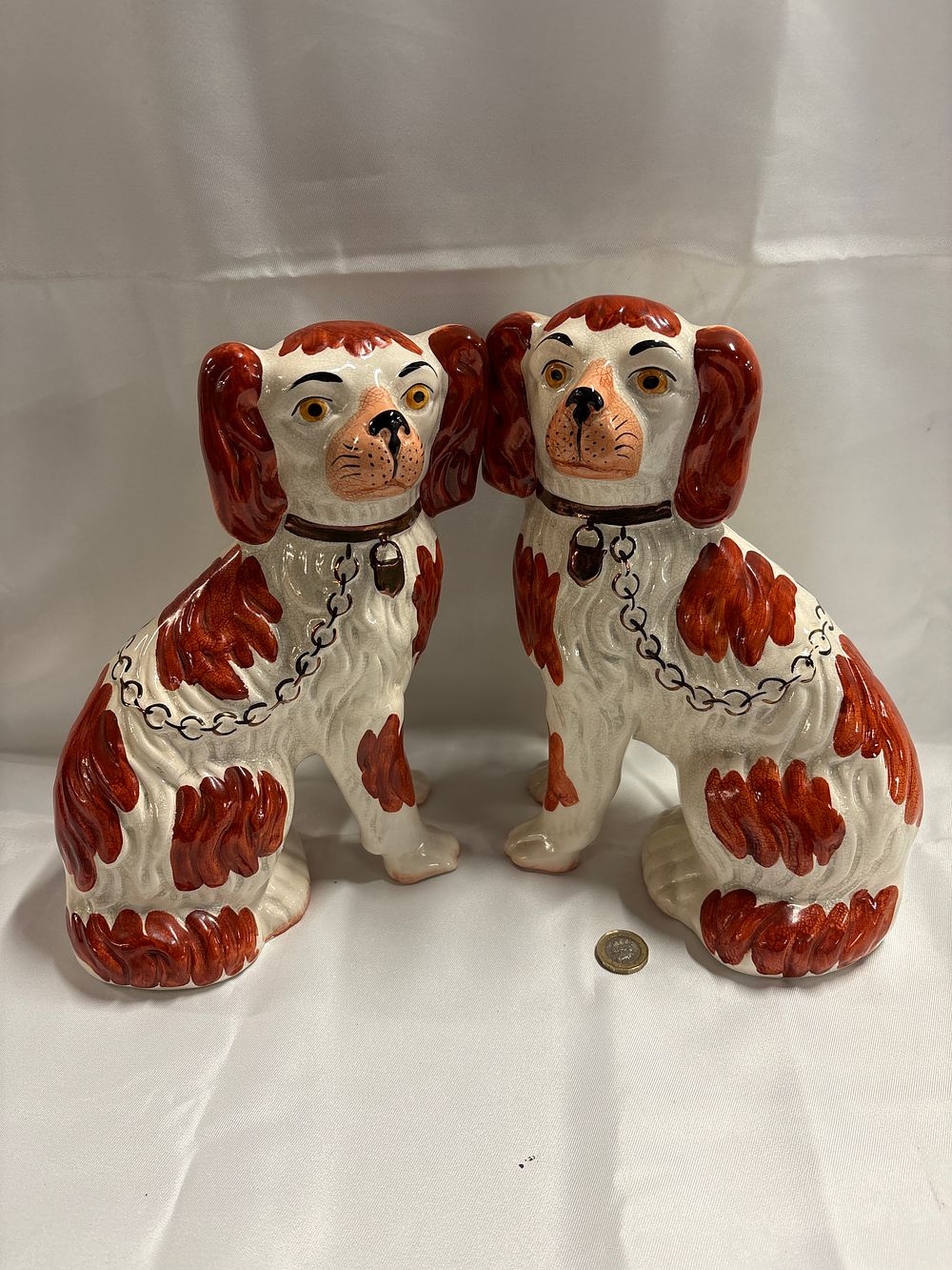 Lot 765: A Pair of Reproduction Staffordshire Style Seated Spaniel Figurines