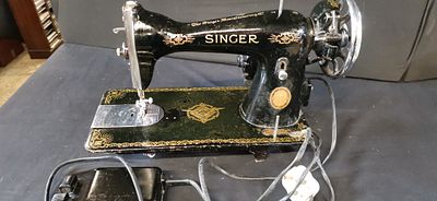 Vintage Singer Electric Sewing Machine with Motor and Foot Controller. A vintage black Singer 