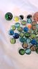 An Assortment of Coloured Glass Marbles with Cat's Eye and Swirl Patterns. A collection of glass Image - 1