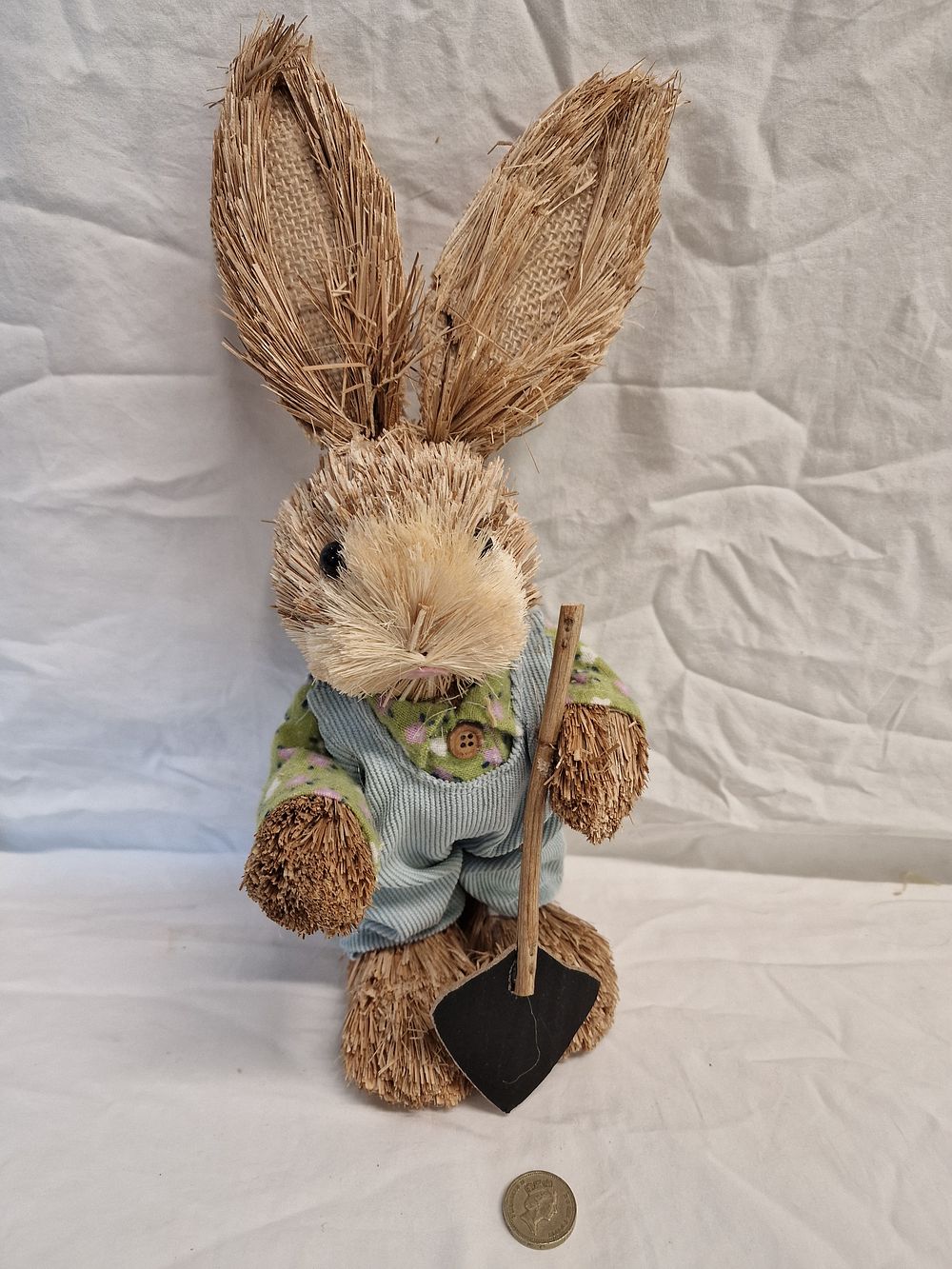 A Decorative Rabbit Figurine with Garden Shovel. A seasonal decorative rabbit figurine 