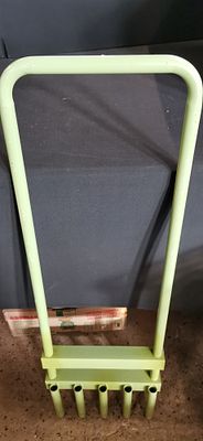 A Manual Five-Tine Hollow Core Lawn Aerator. A manual five-tine hollow core lawn aerator 