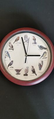 A British Singing Bird Themed Quartz Wall Clock. A circular quartz wall clock featuring a white 