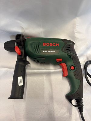 Bosch PSB 680 RE Corded Hammer Drill. A Bosch PSB 680 RE corded hammer drill featuring a green 