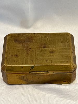 An early 20th-century engine-turned brass pocket cigarette box. A rectangular brass pocket box 
