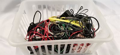 An Assortment of Unsorted Electronic Cables and Power Adapters. A collection of various 