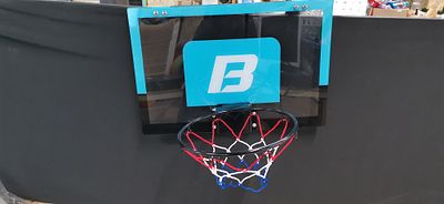 An Over the Door Mini Basketball Backboard and Hoop Set. An indoor mini basketball backboard and 