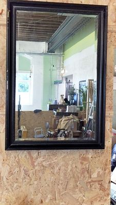 A large late 20th-century wall mirror with a black beaded frame. A large-scale wall mirror 