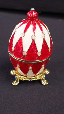 A Faberg&eacute;-style Enamelled Gilt Metal Egg Trinket Box and Stand. A modern enamelled gilt metal 