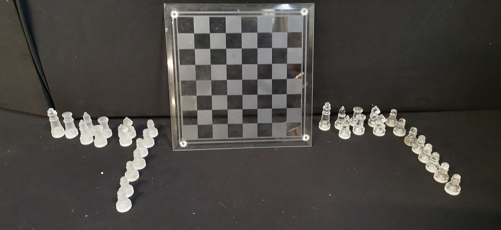 Lot 585: A Glass Chess Set with Square Board and Multiple Glass Pieces