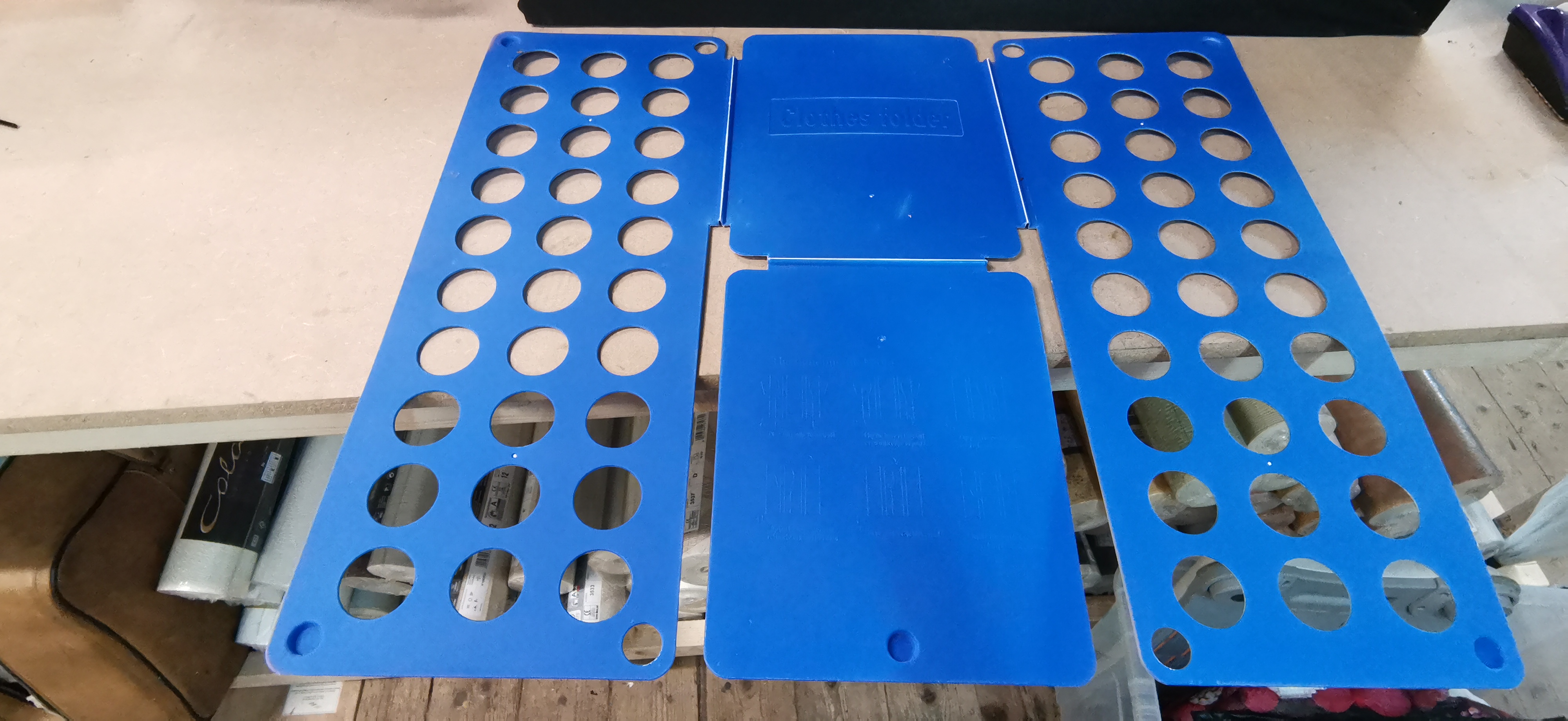 A Blue Plastic Clothes Folding Board