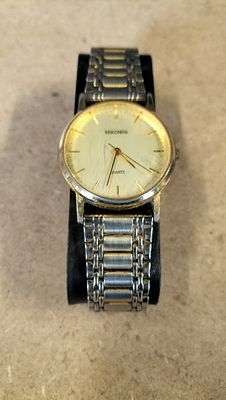 Sekonda two-tone quartz analogue wristwatch with box and guide. A two-tone silver and 