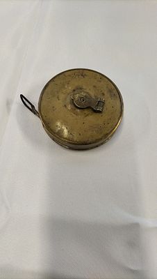 Vintage Lufkin Brass Retractable Tape Measure. A vintage brass-cased retractable tape measure by 