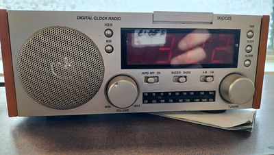 Digital Clock Radio Model WCR-68. A silver and brown digital clock radio featuring an AM/FM 