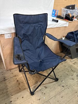 A navy blue folding camping chair with integrated cup holder and carrying bag. A portable 