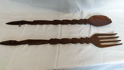 A Pair of Oversized Carved Wood Wall Decor Utensils. A pair of large decorative wooden utensils 