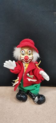 A vintage decorative porcelain and fabric clown doll