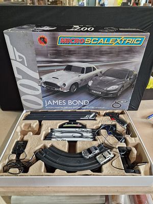 A Micro Scalextric James Bond 007 Aston Martin DB5 and Aston Martin DBS Action Set by Hornby