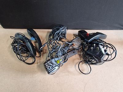 A Collection of Slot Car Controllers, a Rotary Power Tool, and Power Adapters