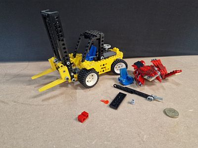 A Collection of LEGO Technic Construction Toy Components featuring a Forklift Transporter