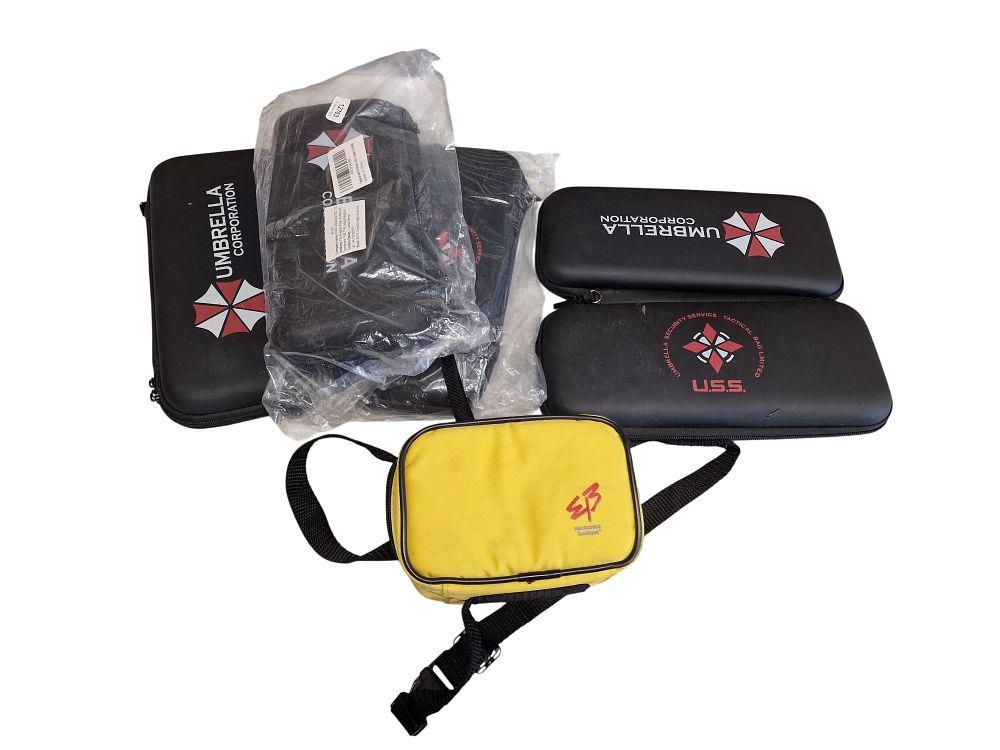 Lot 562: A Collection of Resident Evil Umbrella Corporation Themed Console Cases and an Electronics Boutique Retail Pouch
