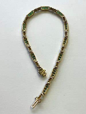 A 9ct yellow gold Emerald & diamond bracelet, set with princess cut emeralds and round 