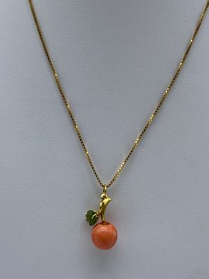 An 18ct yellow gold coral and jade pendant and chain, fully hallmarked, chain is 16 inches long 