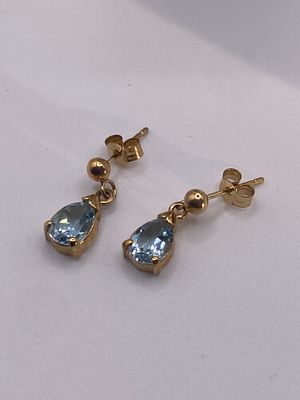 A pair of 9ct yellow gold blue topaz earrings, 1.3 grams in weight approx, 14mm drop, 7mm x 5mm 
