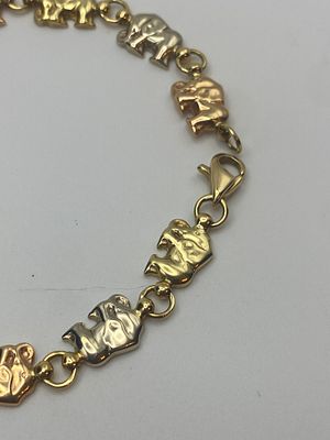 An 18ct yellow, white & rose gold elephant bracelet, unhallmarked but it has been tested 
