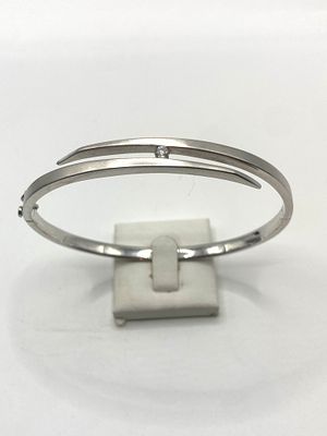 An 18ct white gold diamond set bangle, frosted top, 20 grams in weight approx, very good condition