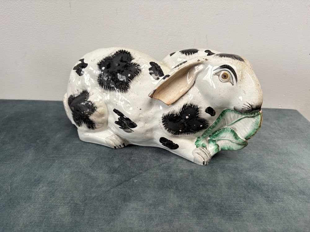 Lot 314: Antique Staffordshire pottery rabbit nibbling leaves