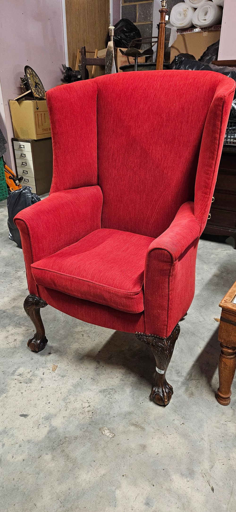 Lot 30: Red upholstered wingback armchair with carved cabriole legs