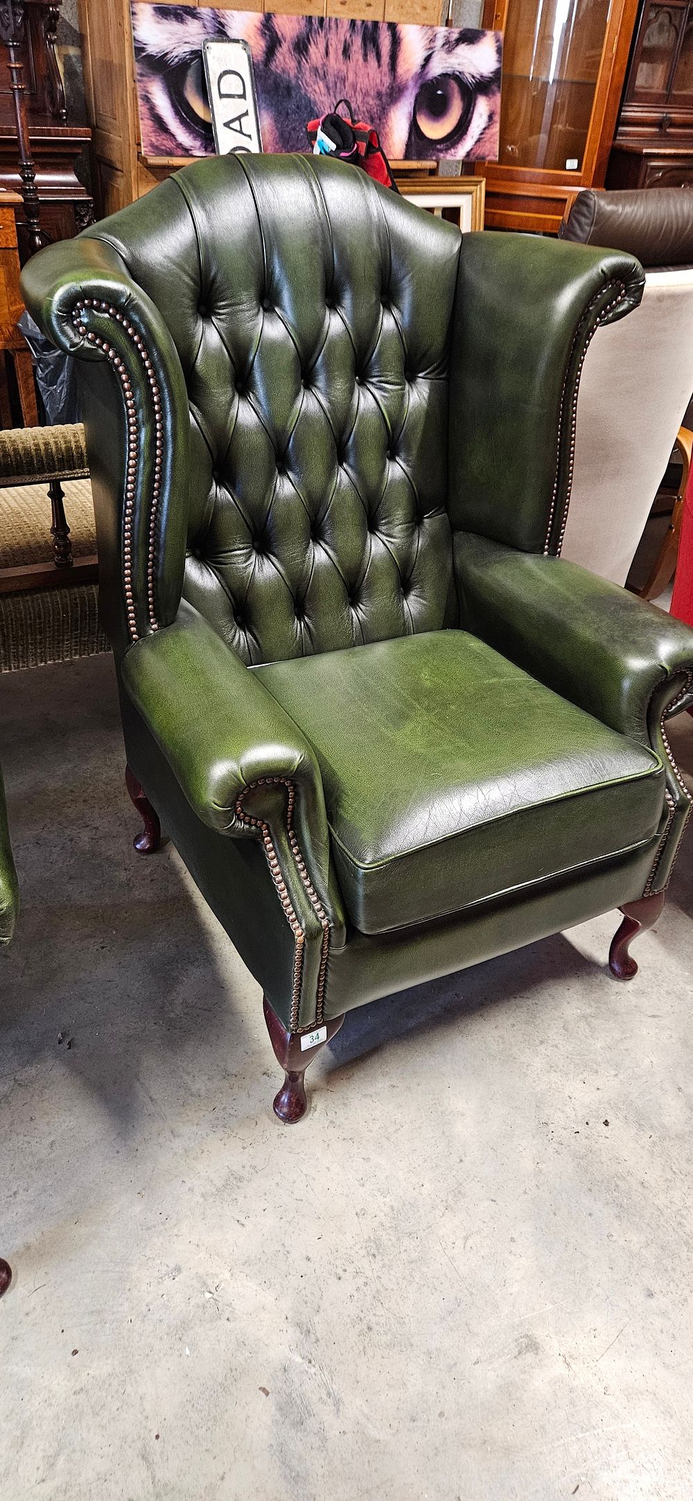 Lot 34: Chesterfield Queen Anne style high-back wing chair in...