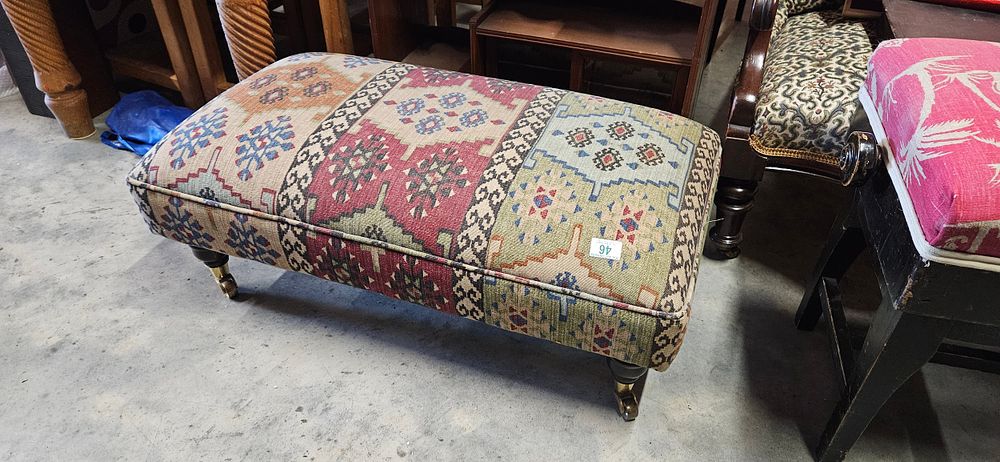 Lot 46: Upholstered kilim style footstool with wooden legs and...