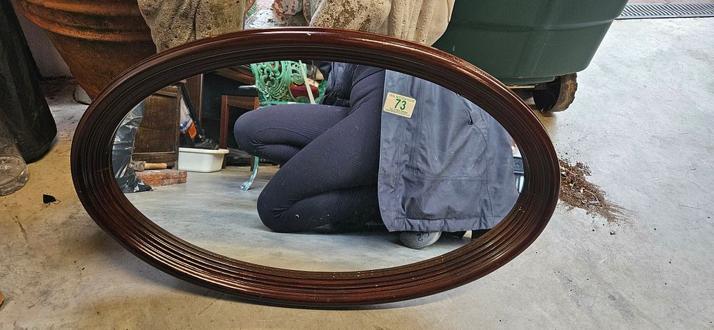 Lot 73: Small oval wall mirror