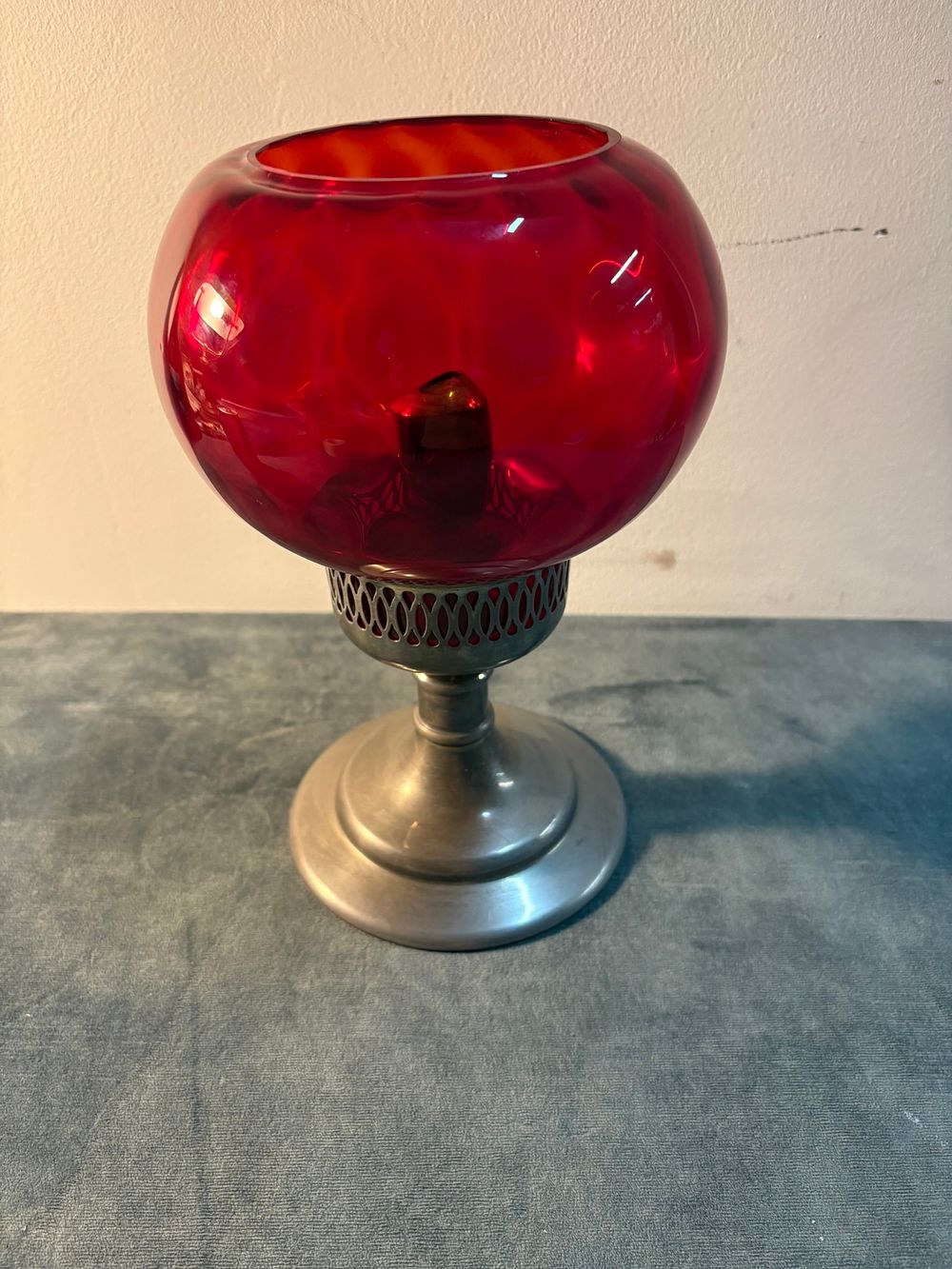 Lot 150: Small red glass and metal candlestick